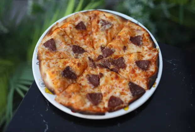 Mini pizza with tomato sauce, mozzarella and beef sucuk