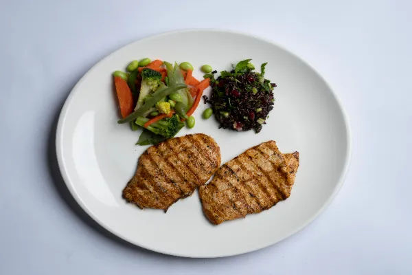 Grilled thyme chicken breast with black rice salad, boiled vegetables and broccoli