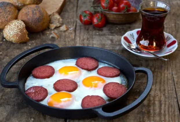 Eggs with sucuk in a pan