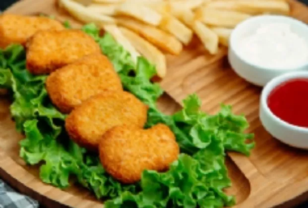 Chicken nuggets with fries and dip sauce
