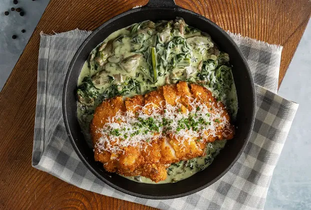 Fried Parmesan Chicken on a Bed of Spinach