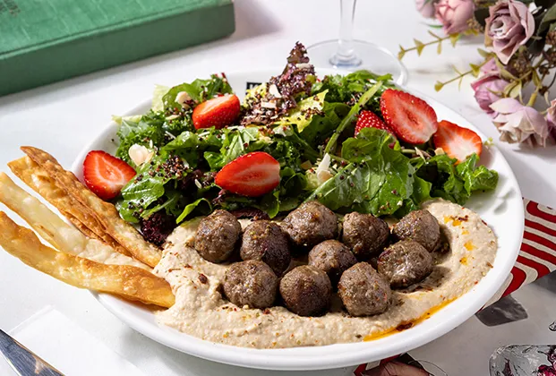 Kale salad with quinoa meatballs on hummus