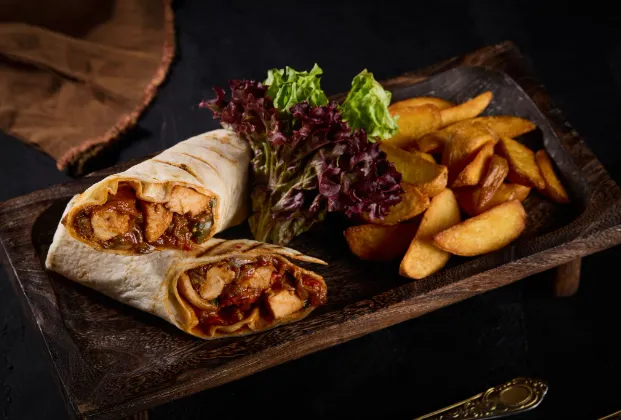 Chicken wrap with French fries and Mediterranean greens