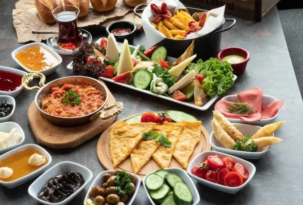 Turkish breakfast spread with gözleme filled with eggs, kavurma and kaşar cheese, served with unlimited tea