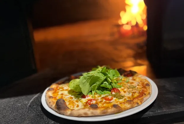 Margherita pizza with pesto and arugula