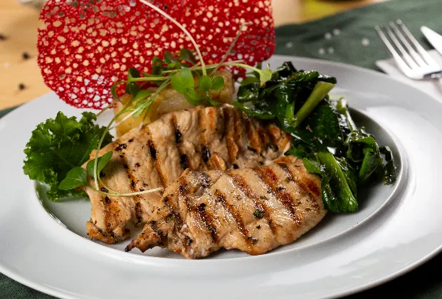 Chicken Külbastı with potato sauté on a bed of spinach