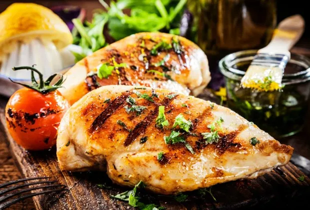Grilled chicken breast with seasonal vegetables and French fries