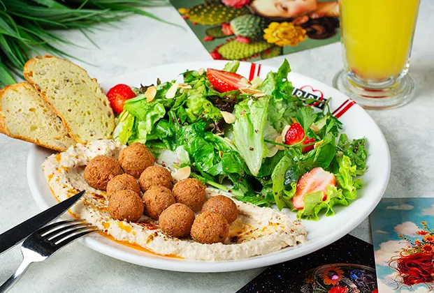 Kale Salad with Quinoa Falafel on a Bed of Hummus