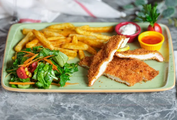 Chicken Schnitzel with French Fries and Seasonal Greens