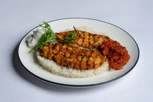 Peri-peri chicken with rice, tomato salsa and sour cream