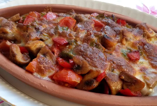 Mushrooms with kaşar cheese in a clay casserole