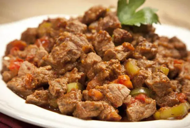 Meat sauté with creamy tomato sauce, French fries and rice pilaf