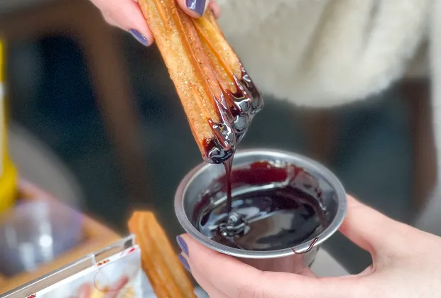 2 churros with chocolate sauce