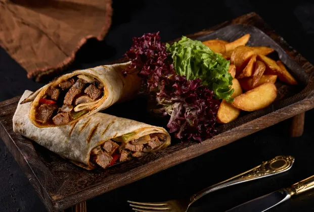 Beef tenderloin wrap with fries and Mediterranean greens