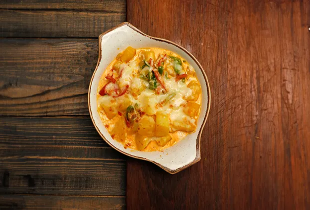 Baked potatoes with cheddar sauce