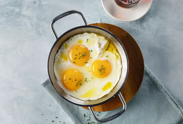 3 eggs cooked in butter in a pan