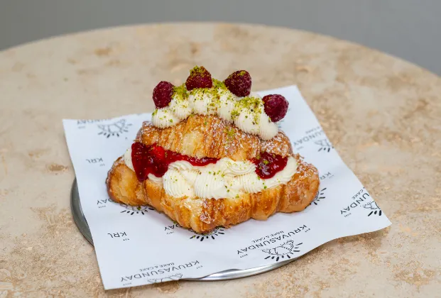 Croissant with pastry cream and raspberry sauce